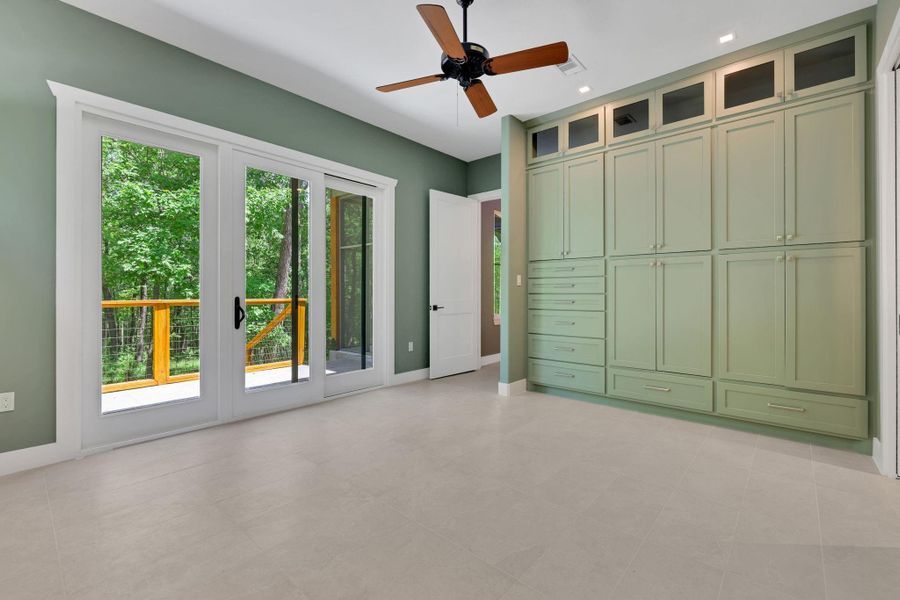 The primary suite features large sliding doors to its own patio and custom built-in storage.