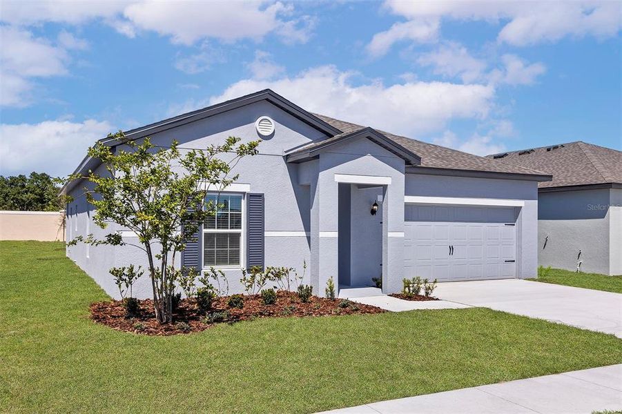 Front exterior of a new home in Peach Crossings, Winter Haven, FL, highlighting curb appeal (Image 1). Front exterior of a new home in Peach Crossings, Winter Haven, FL, highlighting curb appeal (Image 1).