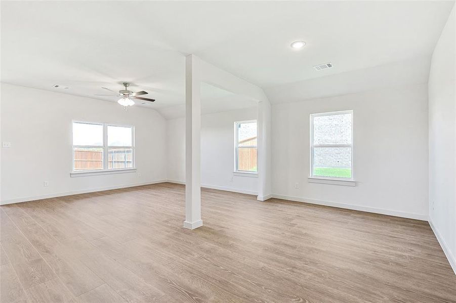 Spare room with light wood-type flooring and ceiling fan