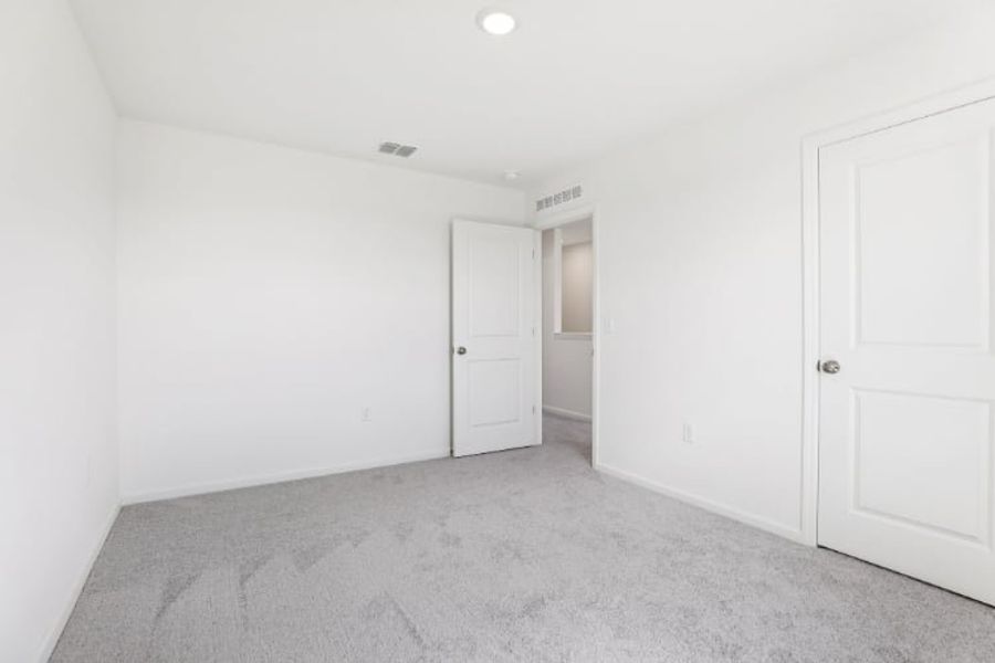 A hallway with white doors.