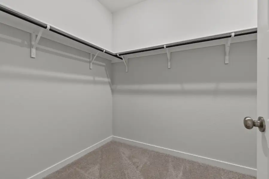 A white wall with a metal railing. A white wall with a metal railing.