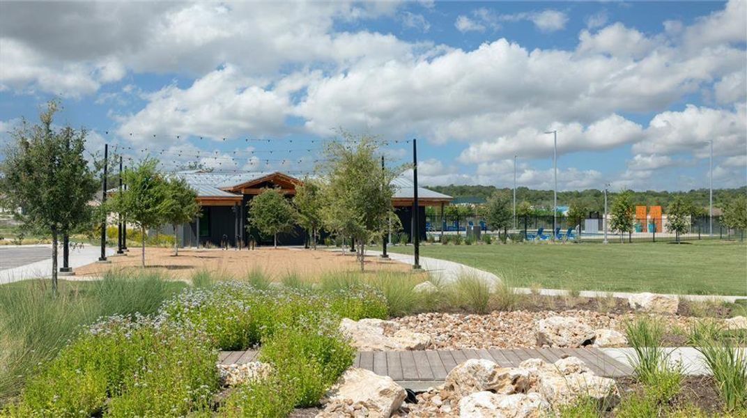 Discover a community gathering space with lush landscaping, a vibrant green lawn, and inviting outdoor amenities. Discover a community gathering space with lush landscaping, a vibrant green lawn, and inviting outdoor amenities.