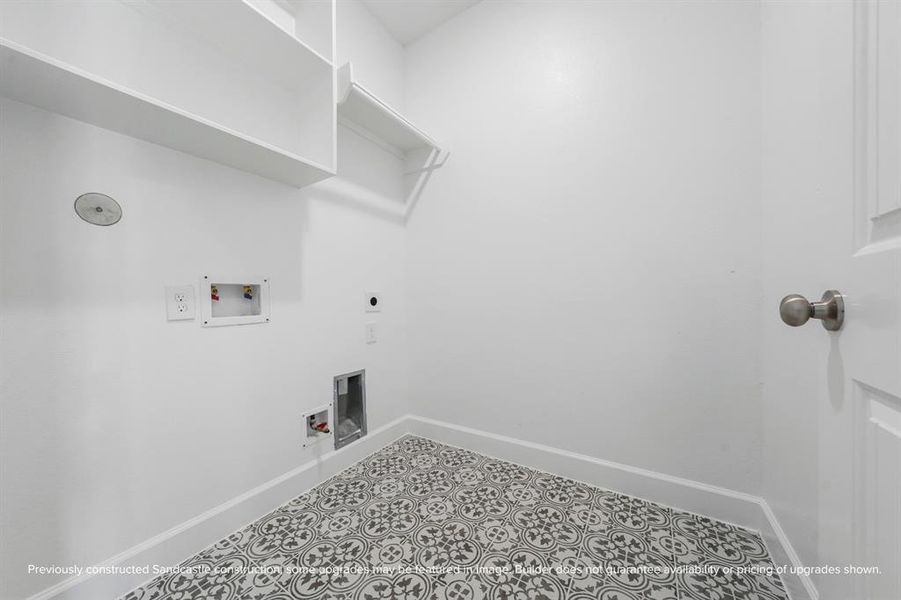 Functional Utility Room – The utility room features beautiful tile, shelving, and plenty of space for laundry and storage needs.