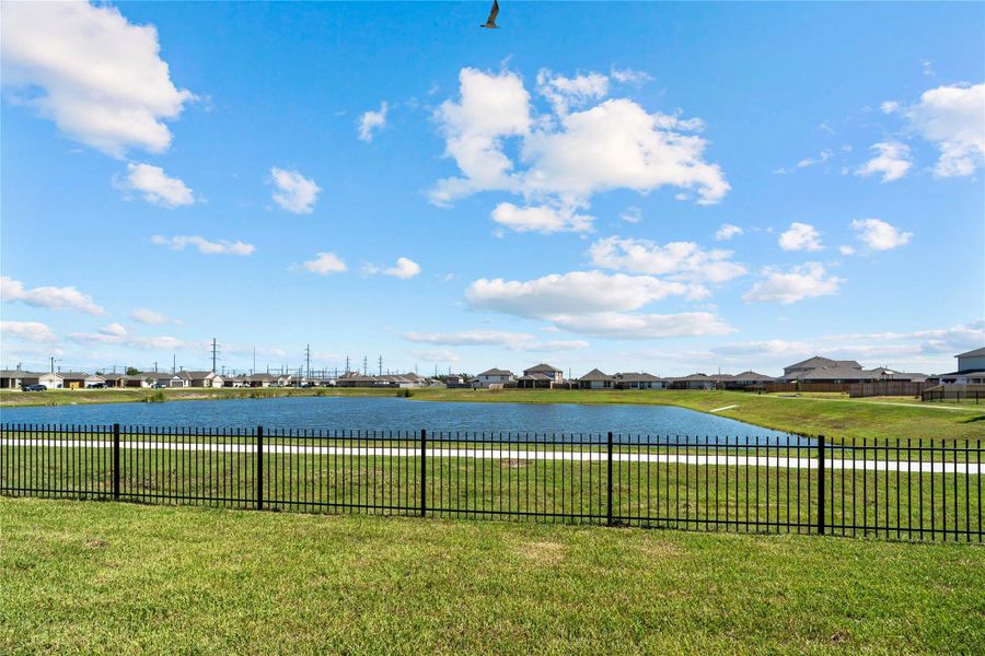 Charming backyard view showcasing the community lake and walking path! Charming backyard view showcasing the community lake and walking path!