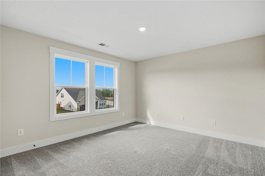 Plush carpeting and large dual windows define this
