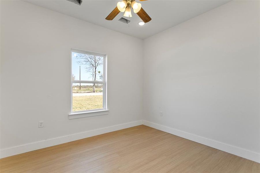 Unfurnished room featuring ceiling fan and light hardwood / wood-style floors