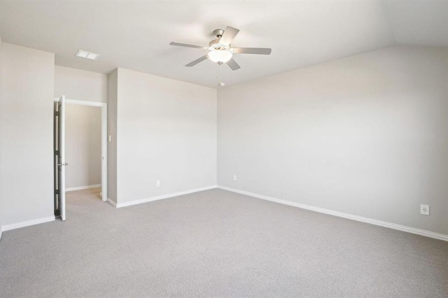Empty room featuring light carpet and ceiling fan Empty room featuring light carpet and ceiling fan