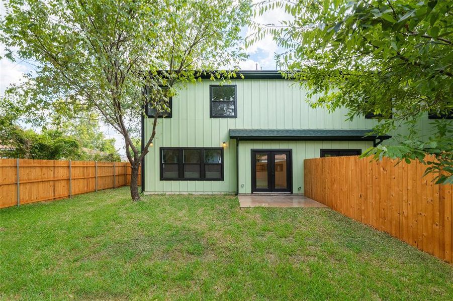 Back of property with a patio and a lawn