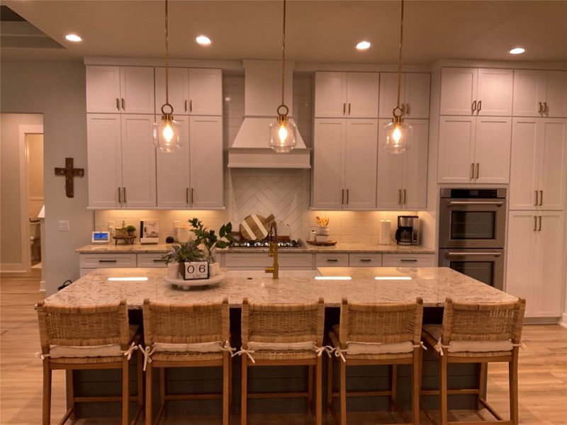 custom shaker style cabinetry in kitchen goes to ceiling, large island seats 5