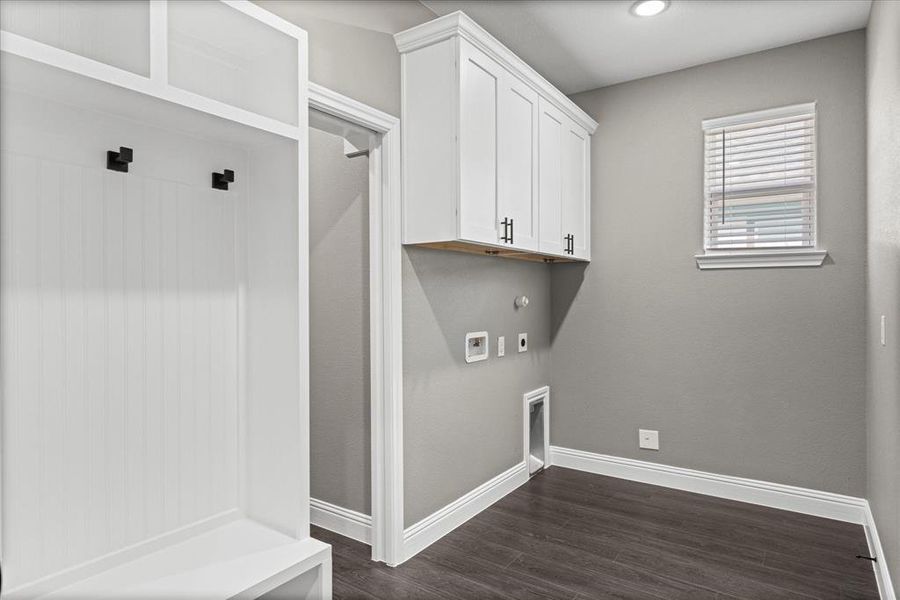 Laundry / Mud Room area featuring cabinets, dark hardwood / wood-style floors, washer and dryer hook-ups. Access from the garage, hallway or Primary BR closet