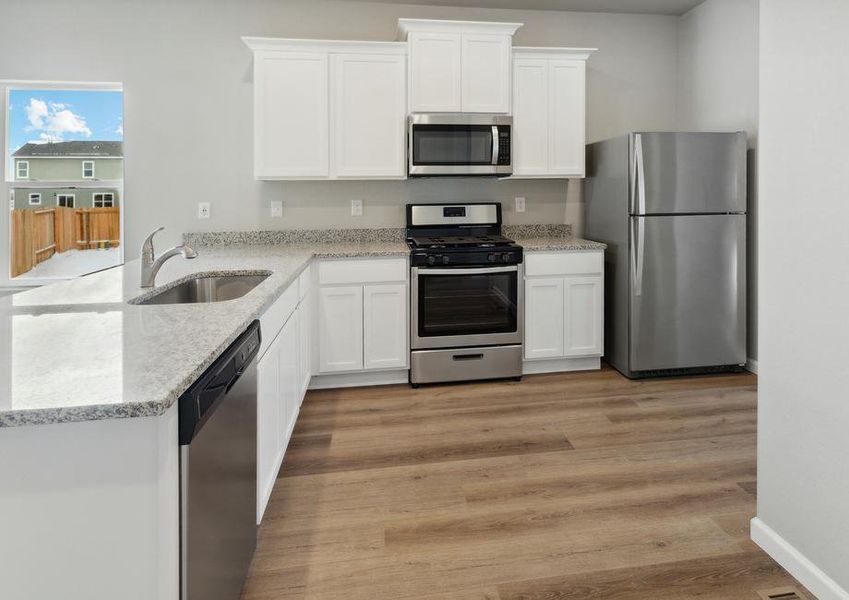 The kitchen of the Arapaho has beautiful white wood cabinets.