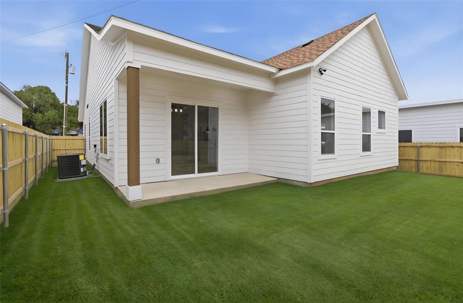 Rear view of house with a fenced backyard, a patio, and roof with shingles