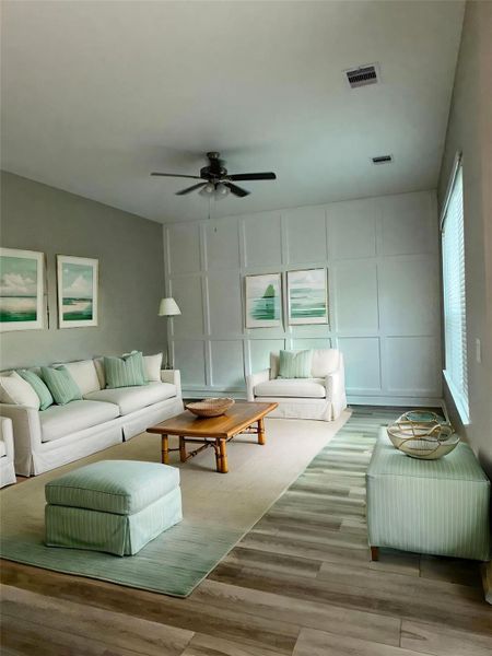 This living Space Features and expansive, light filled area with large windows and a versatile layout perfect for entertaining and everyday living. Image depicts home as-is virtually staged.