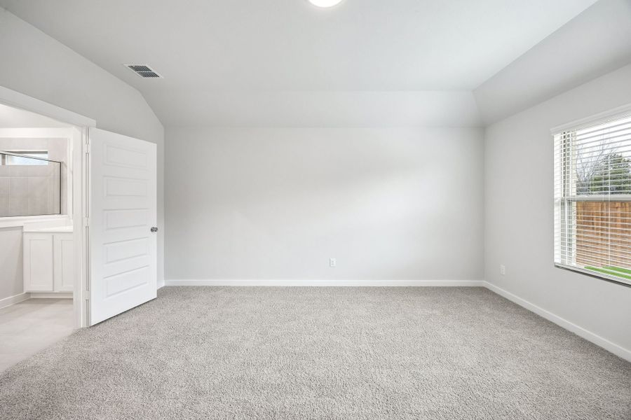 Primary Suite in the Heisman home plan by Trophy Signature Homes – REPRESENTATIVE PHOTO