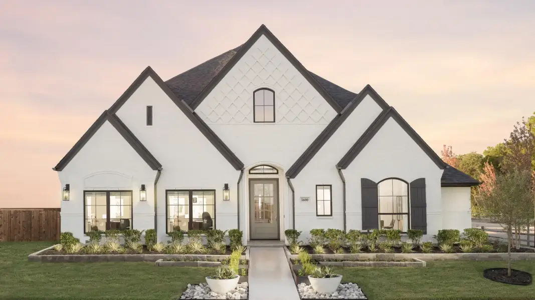 Front exterior of a new home in Parkside on the River West, Georgetown, TX, highlighting curb appeal (Image 2).