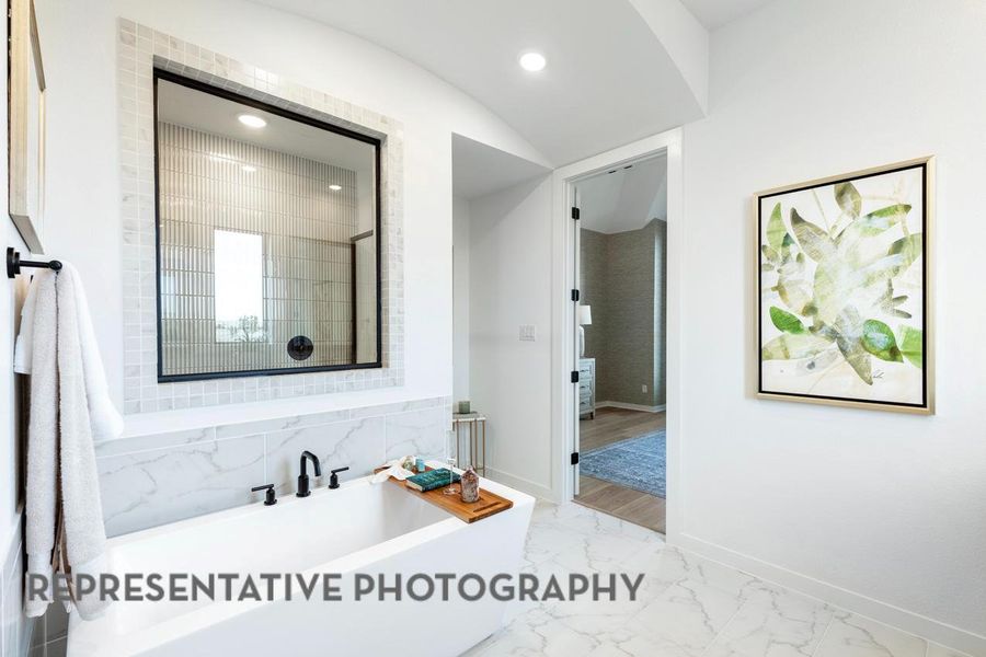 Full bathroom with marble finish flooring, a freestanding tub, baseboards, and recessed lighting
