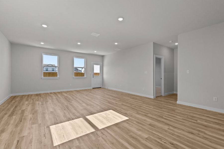 A room with a wood floor and a rug in it.