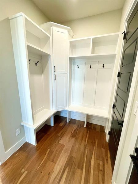 Mudroom with dark wood finished floors