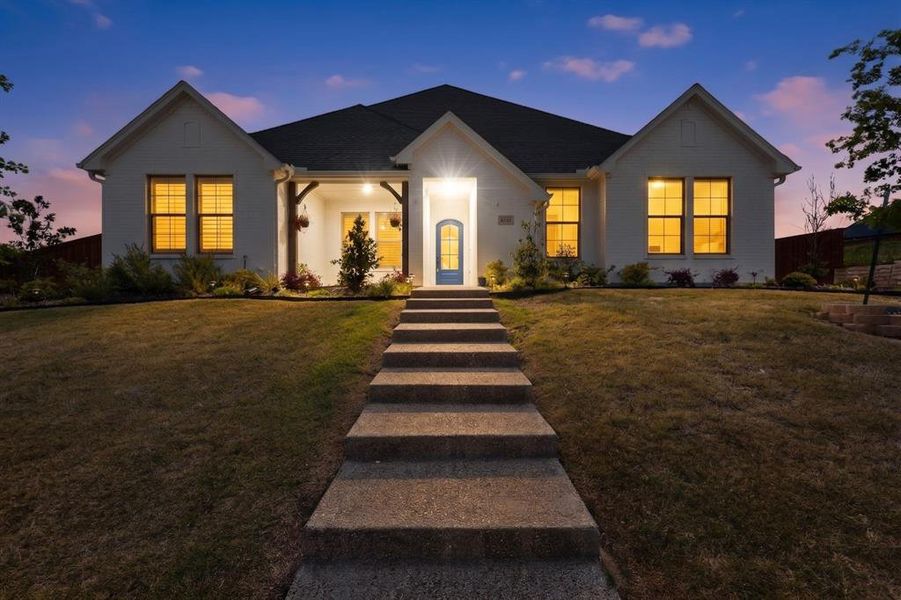 White brick exterior featuring a gabled roofline and covered front porch White brick exterior featuring a gabled roofline and covered front porch