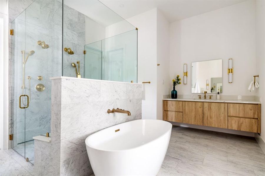 Full bath with a soaking tub, a marble finish shower, vanity, and tile walls Full bath with a soaking tub, a marble finish shower, vanity, and tile walls