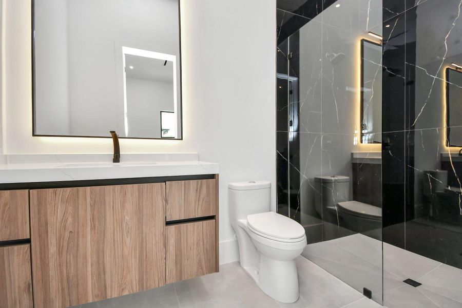 Step into luxury with this stunning bathroom featuring a spacious walk-in shower, modern hardware, and sleek tile extending from floor to ceiling. Step into luxury with this stunning bathroom featuring a spacious walk-in shower, modern hardware, and sleek tile extending from floor to ceiling.