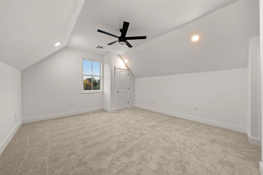 Additional living space with light carpet, lofted ceiling, recessed lighting, and ceiling fan Additional living space with light carpet, lofted ceiling, recessed lighting, and ceiling fan