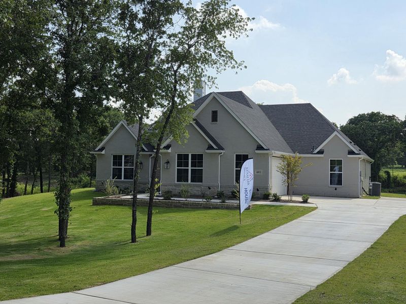 Front exterior of a new home in Escondido Ranches, Poolville, TX, highlighting curb appeal (Image 25). Front exterior of a new home in Escondido Ranches, Poolville, TX, highlighting curb appeal (Image 25).