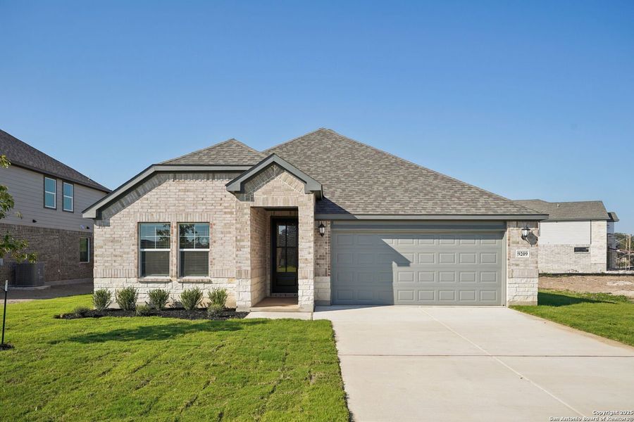 Front exterior of a new home in Carmel Ranch, Schertz, TX, highlighting curb appeal (Image 2). Front exterior of a new home in Carmel Ranch, Schertz, TX, highlighting curb appeal (Image 2).