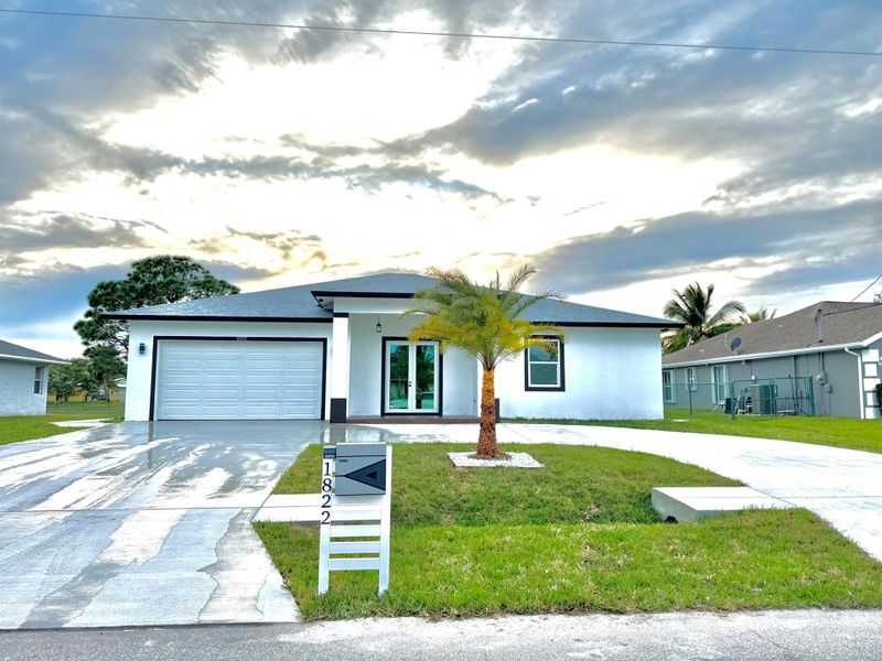 Front exterior of a new home in , Port St. Lucie, FL, highlighting curb appeal (Image 2).