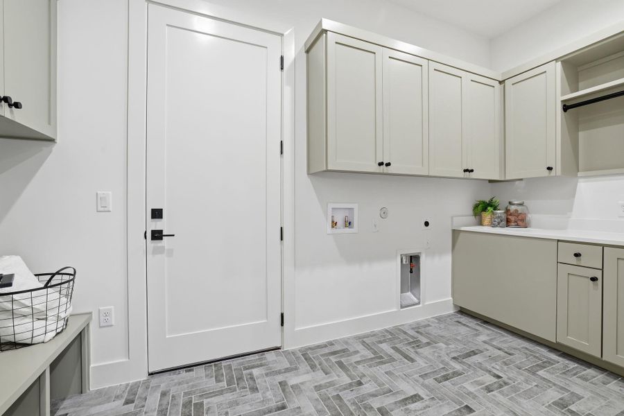 Washroom featuring gas dryer hookup, washer hookup, hookup for an electric dryer, and cabinet space