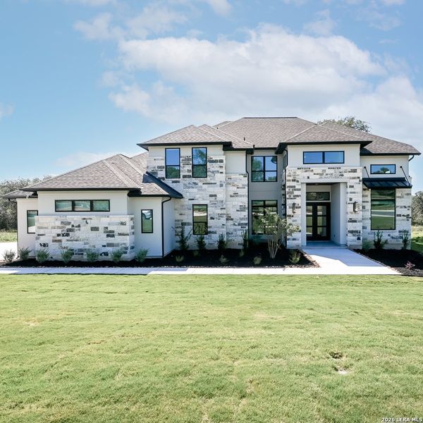 Front exterior of a new home in Thornebrook, Bulverde, TX, highlighting curb appeal (Image 1). Front exterior of a new home in Thornebrook, Bulverde, TX, highlighting curb appeal (Image 1).