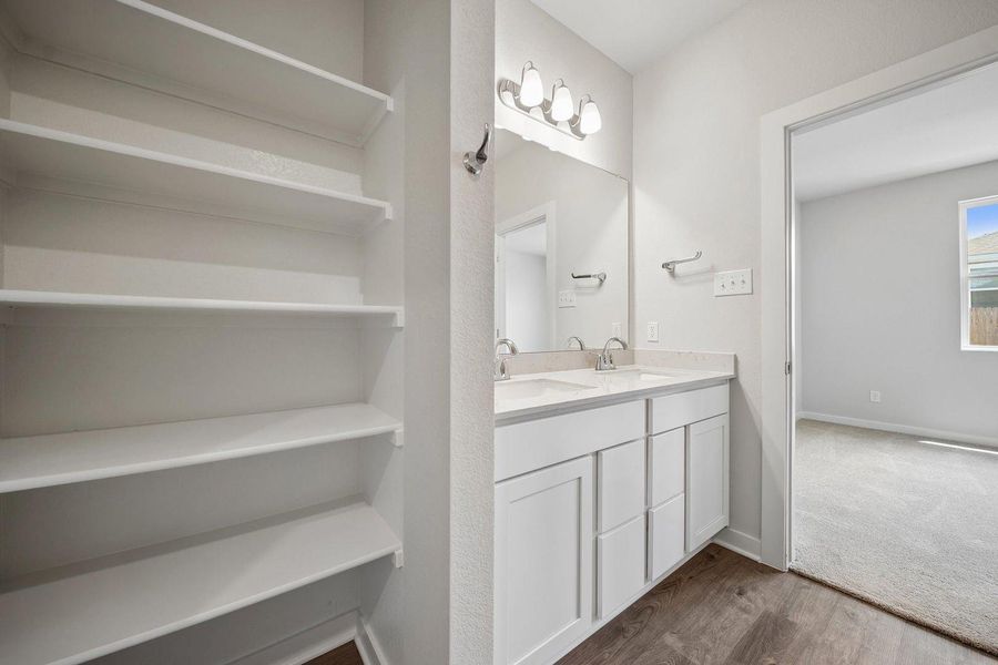 Double vanity and ample built-in storage create a functional and organized bathroom space. Double vanity and ample built-in storage create a functional and organized bathroom space.