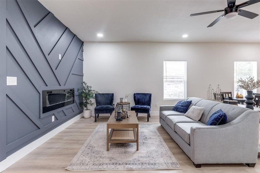 Living room featuring light wood-type flooring and ceiling fan