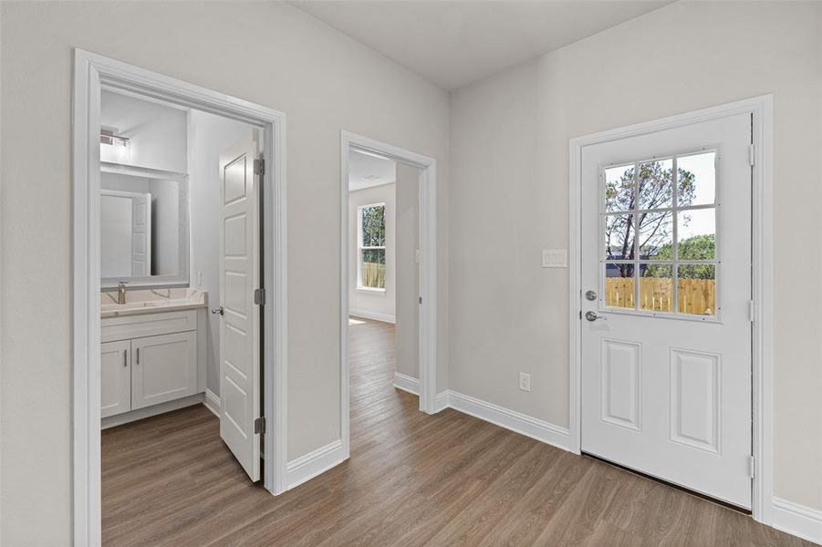 Foyer entrance featuring light hardwood / wood-style flooring and sink