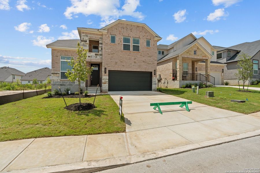 Front exterior of a new home in Hunters Ranch, San Antonio, TX, highlighting curb appeal (Image 29). Front exterior of a new home in Hunters Ranch, San Antonio, TX, highlighting curb appeal (Image 29).