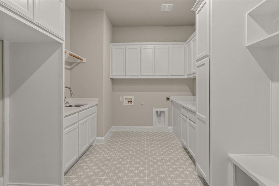 Clothes washing area featuring sink, cabinets, hookup for a washing machine, hookup for an electric dryer, and hookup for a gas dryer