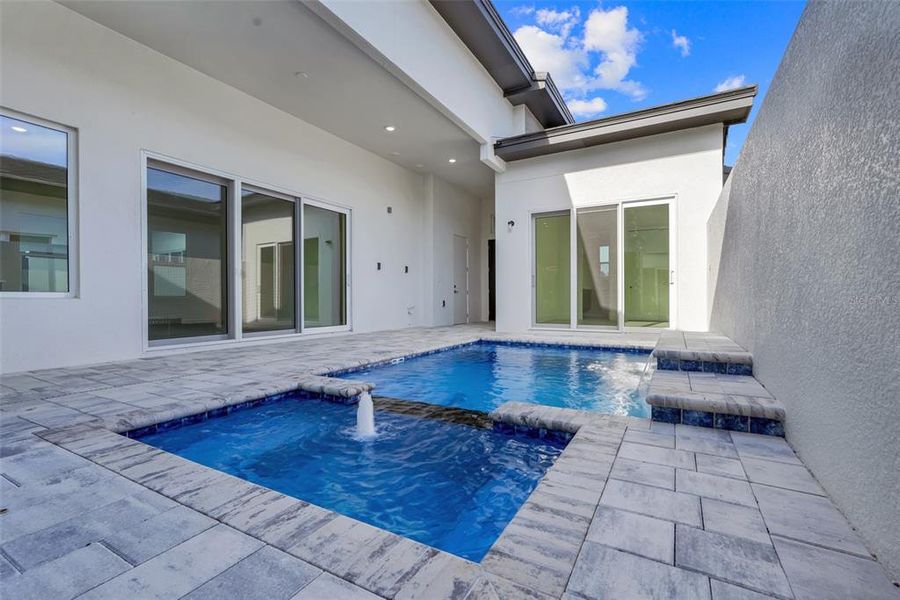 Exterior details and patio area of a home in Hampton Green at Providence, Davenport (Image 27).