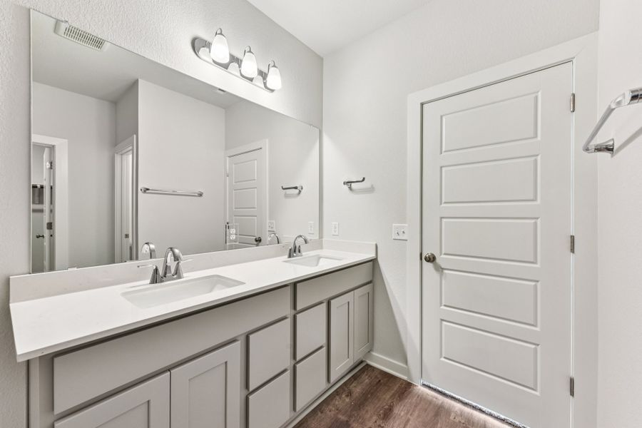A bathroom with a large mirror.