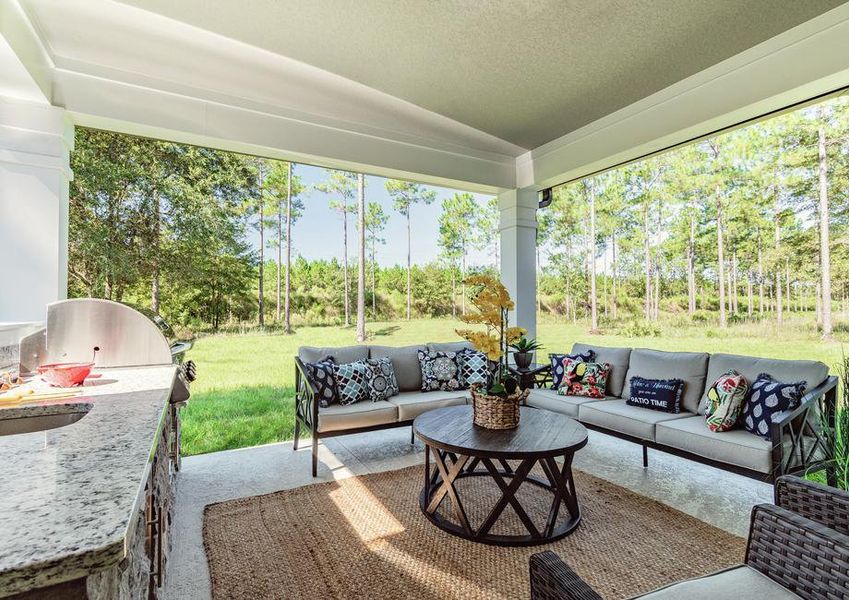 Covered outdoor kitchen with furniture.