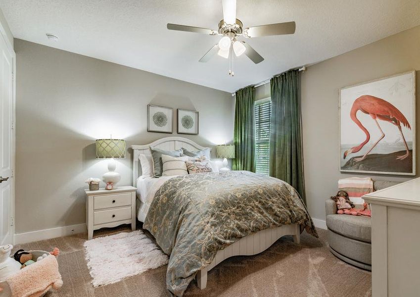 Little girl bedroom with bed, nightstand and artwork.