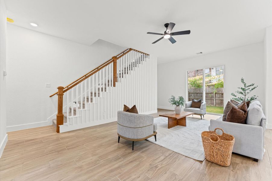 Elegant staircase with wood steps, iron spindles, and subtle LED lighting along the stairway, adding a luxurious touch to the home’s design. Elegant staircase with wood steps, iron spindles, and subtle LED lighting along the stairway, adding a luxurious touch to the home’s design.