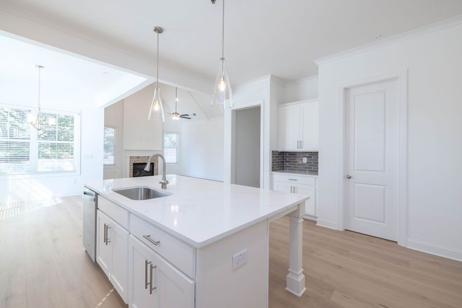 The kitchen opens to the breakfast area and family room