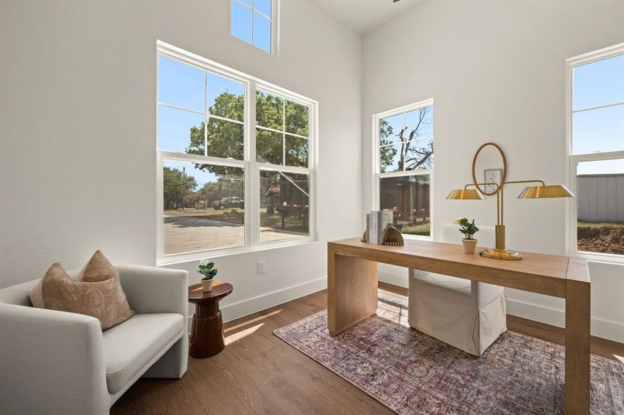 Office space with wood finished floors and baseboards Office space with wood finished floors and baseboards