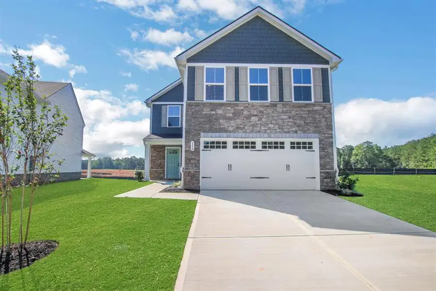 Front exterior of a new home in Aspen Meadows, Hampton, GA, highlighting curb appeal (Image 1).