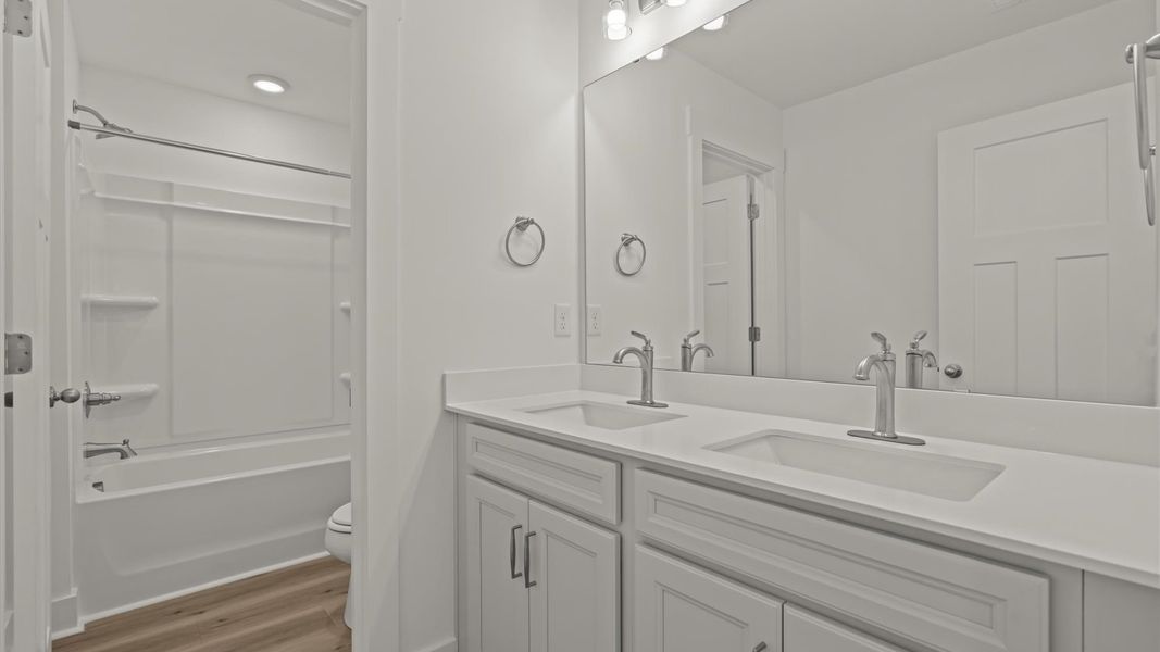 Highly skilled design seen in this polished and practical full bathroom