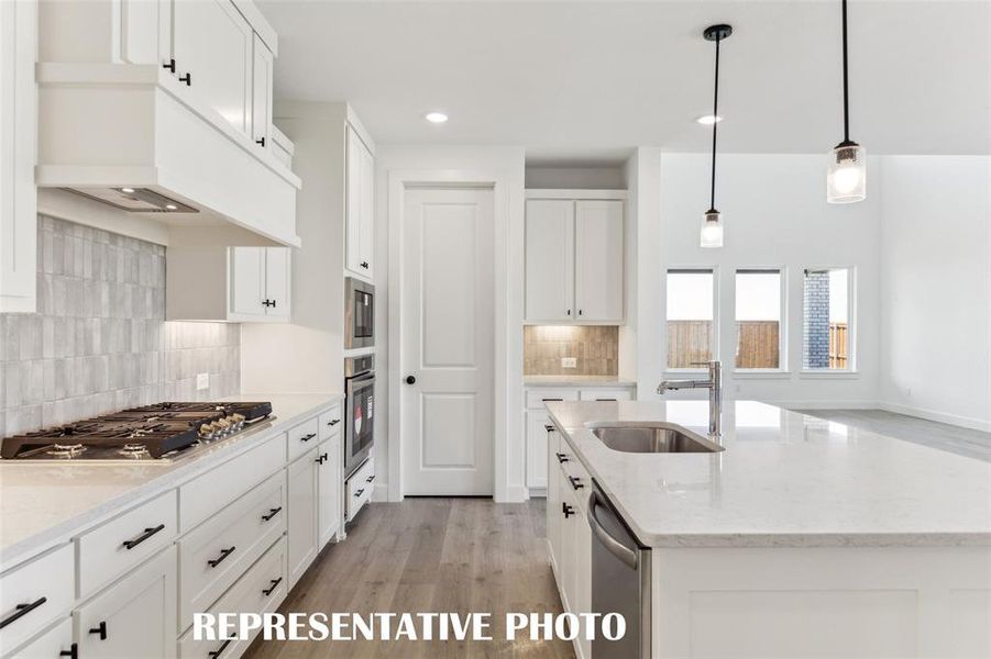 Beautiful cabinetry paired with a designer backsplash and gorgeous countertops make this kitchen standout from the crowd!  REPRESENTATIVE PHOTO