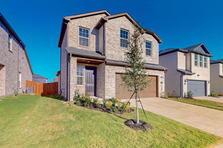 View of front of house with a front lawn and a garage