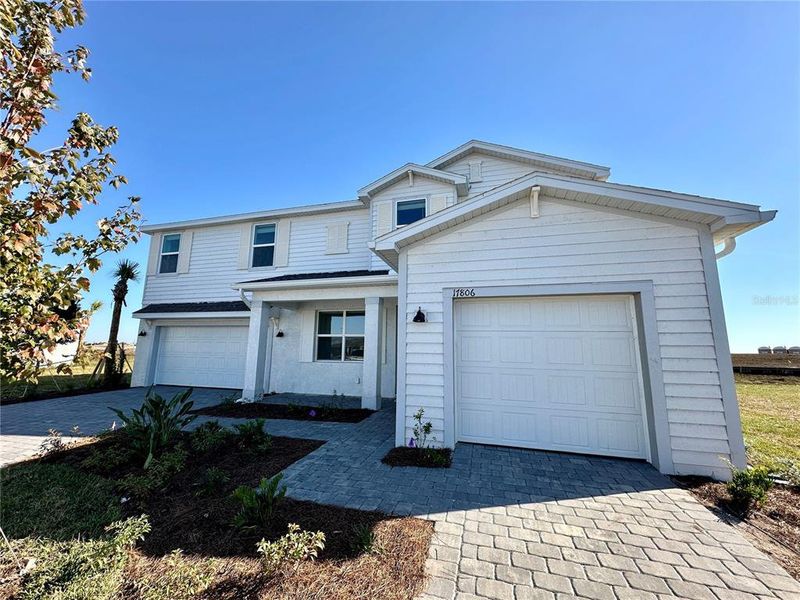 Front exterior of a new home in Rye Ranch: Manor Homes, Parrish, FL, highlighting curb appeal (Image 1). Front exterior of a new home in Rye Ranch: Manor Homes, Parrish, FL, highlighting curb appeal (Image 1).