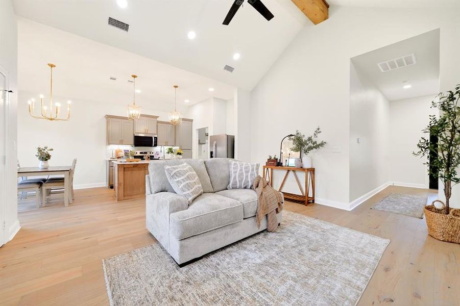 Vaulted ceiling with exposed wood beam and ceiling fan