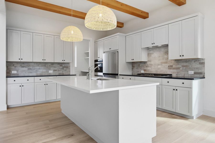 Kitchen with quartz countertops and walk-in pantry